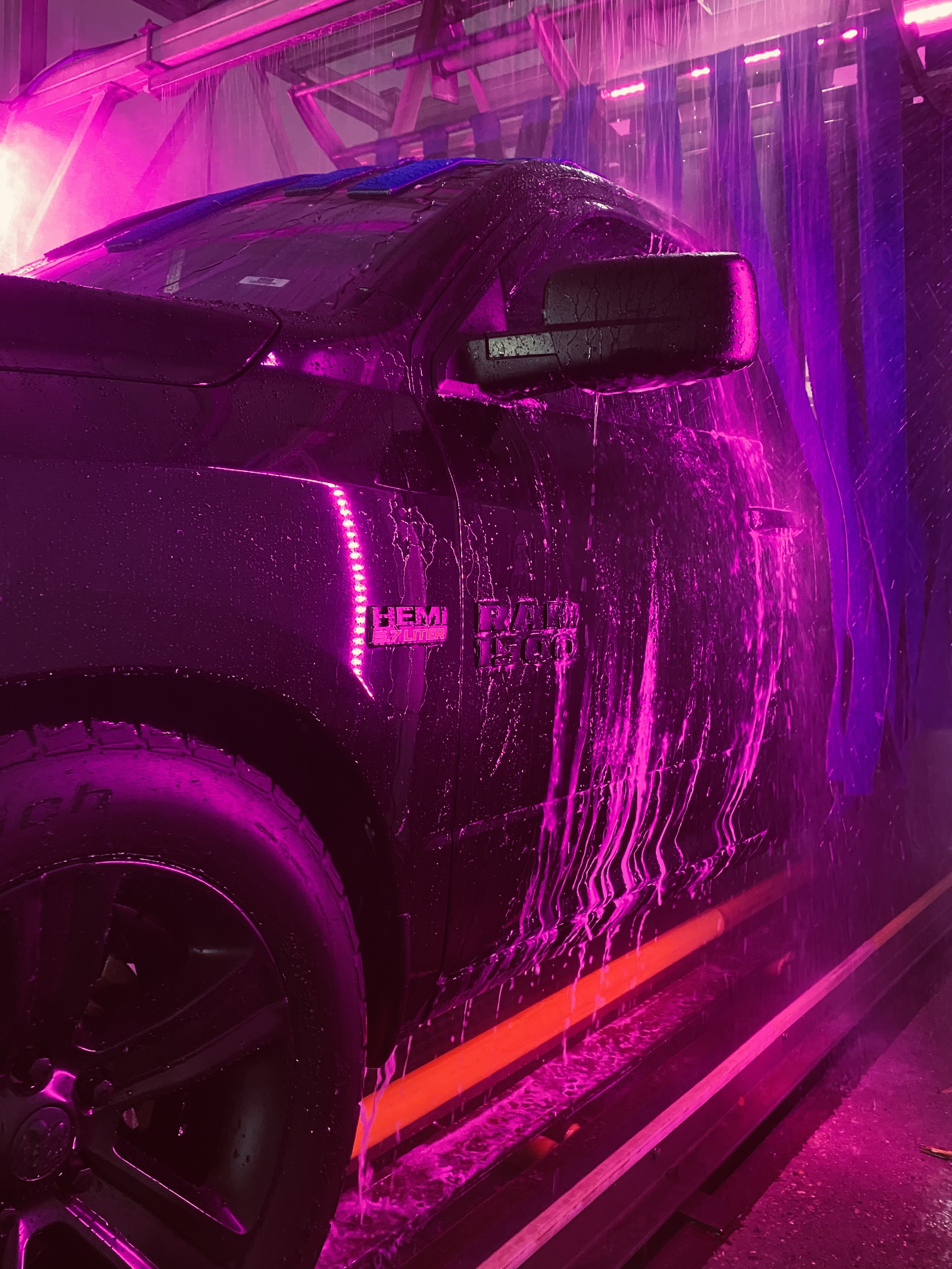 Truck in the express wash tunnel with purple lights